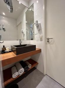 a bathroom with a sink and a shower at Tussenrenesseenstrand in Renesse