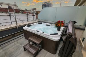 a jacuzzi tub on the roof of a building at PRESTIGE BOUTIQUE APARTHOTEL -Piazza Duomo in Milan