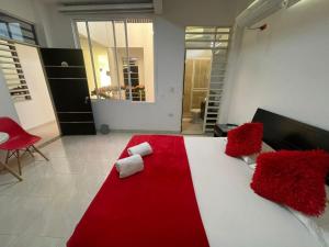 a bedroom with a red and white bed with a red blanket at Hotel Gran Estacion Florencia in Florencia