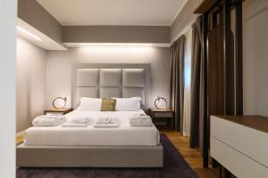 a bedroom with a white bed with two towels on it at PRESTIGE BOUTIQUE APARTHOTEL -Piazza Duomo in Milan