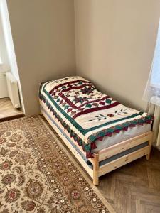 a small bed in a corner of a room at Apartmán Colette in Prague