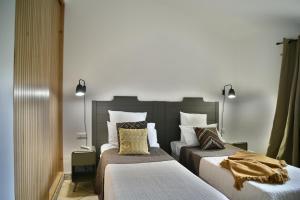 two beds sitting next to each other in a room at Concadoro in Porto-Vecchio