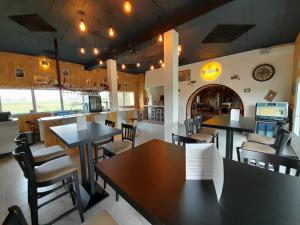 a dining room with tables and chairs in a restaurant at Le Moulin du Comte in Bourrouillan