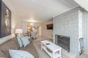 a living room with a couch and a fireplace at 207B One Bedroom One Bath in Oakland