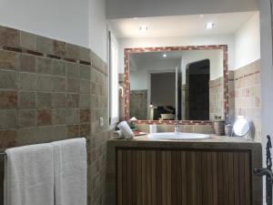 a bathroom with a sink and a mirror at Concadoro in Porto-Vecchio +25 photos