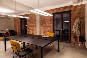 a dining room with a black table and yellow chairs at Spazio Corrado in Corigliano Calabro