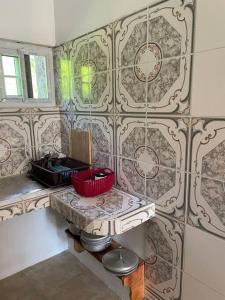 a kitchen with a counter and a wall with tiles at GraceWay Studio Apt with A/C -3mins walk to beach in Negril