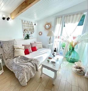 a living room with a white couch and a table at Casa Luciana in Saint-Priest