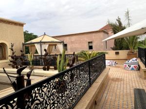 a balcony with a black fence and a gazebo at Villa Coty Palmeraie in Marrakesh