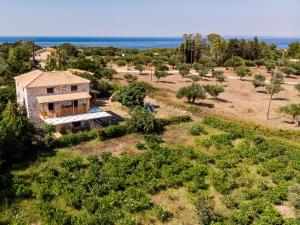 an aerial view of a house with the ocean in the background at Abeloklima country house in Vasilikos