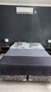 a bedroom with a large bed with two pillows at Casa Familiar in La Rioja