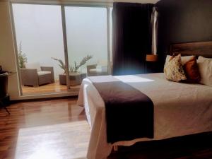 A bed or beds in a room at Hotel CLARUM 101