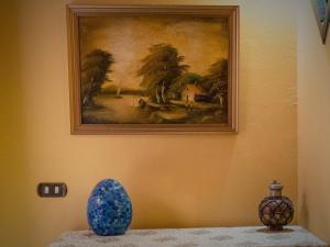 a picture of a painting on a wall with a vase at Alf Leila Boutique Hotel in Dahab