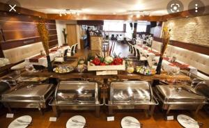 a restaurant with a buffet line with tables and chairs at Velvet Studio Zoned Kopaonik in Kopaonik