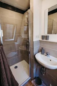 a bathroom with a shower and a sink at Gemütliches Nurdachhaus im Naturparadies mit Sauna - Erholung pur in Bad Wünnenberg +20 photos