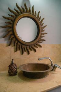 a mirror on a wall above a sink at Alf Leila Boutique Hotel in Dahab