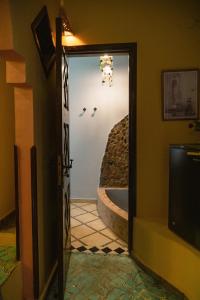 an open door to a bathroom with a tub at Alf Leila Boutique Hotel in Dahab