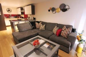 a living room with a couch and a table at Spacious 2 Bed, 2 Bath apartment -The Shore, Leith in Edinburgh