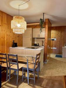 a kitchen and dining room with a table and chairs at Desiree Apartment in Folgarida