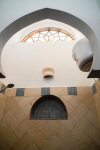 a room with a ceiling with a window and a fireplace at Alf Leila Boutique Hotel in Dahab