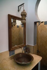 a bathroom with a sink and a mirror at Alf Leila Boutique Hotel in Dahab