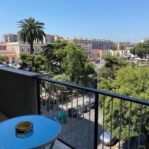 a balcony with a table and a view of a city at Central Station Suite Apartment in Bari