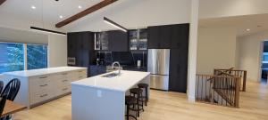 a kitchen with white countertops and black cabinets at Fernie Escape - Mountain Home on the Ski Hill in Fernie
