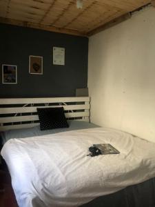 a bedroom with a white bed with a book on it at Safariadventures-House in Arusha