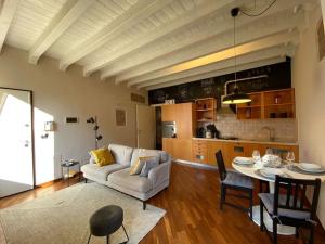 a living room with a couch and a table at A view on Brescia's rooftops in Brescia