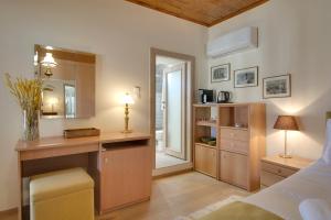 a bedroom with a bed and a kitchen with a desk at Casa Margarita cozy & peaceful stay in Tzoumerka in Ioannina