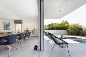 a patio with a table and chairs and a pool at Casa Chamizo in Cambrils