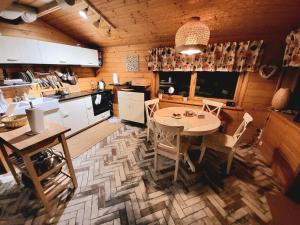 a kitchen and dining room with a table and chairs at Wheelchair With Wings in Jaworzynka