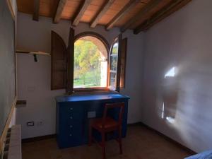 a room with a blue dresser and a window at Loft in Chianti in medieval watermill in Gaiole in Chianti