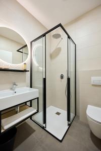 uma casa de banho com um chuveiro e um lavatório. em Guesthouse Na trati em Črna na Koroškem
