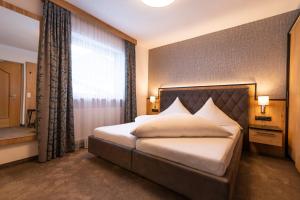 Łóżko lub łóżka w pokoju w obiekcie Hotel Garni Försterheim