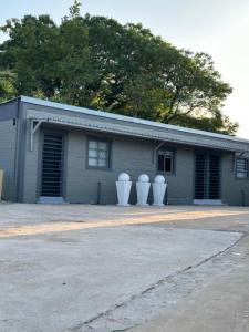 a building with three white vases in front of it at One Home in Pretoria