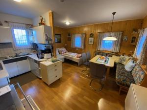 a kitchen and a living room with a table at Troadkastn Familie Fritz in Passail