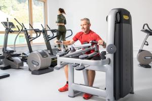a man on a treadmill in a gym at Gesundheits- & Wellnessresort Salzerbad in Kleinzell