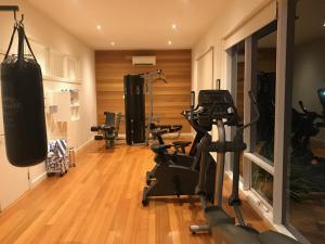 a gym with several tread machines in a room at Couple's Resort Spa Retreat in Cowes