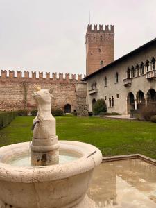 a stone fountain in front of a castle at River Castle Central Verona in Verona +8 photos