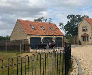 a black truck parked in front of a house at Entire Loft Space in quiet village near Roman City of Lincoln in Lincoln