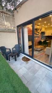 a patio with some chairs and a table and windows at BayMari Suites Plus Florya in Istanbul