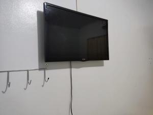 a flat screen tv hanging on a white wall at HOTEL REAL in Marechal Cândido Rondon