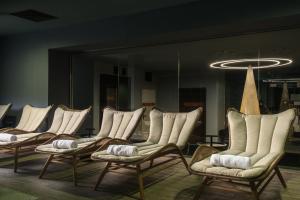 a row of chairs in a room with a mirror at Ores Boutique Hotel in Bansko