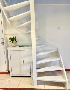 a staircase with white shelves in a room at Fila Stroo in Kamperland