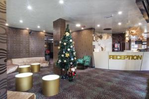 a christmas tree in the lobby of a store at Ores Boutique Hotel in Bansko