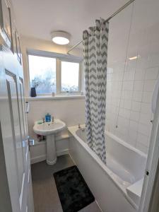 a bathroom with a sink and a toilet and a shower at LTK Basildon in Nevendon
