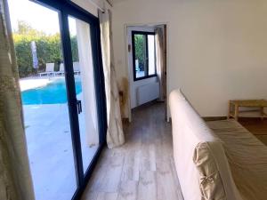 a room with a sliding glass door leading to a pool at Maison Piscine Sauna 5min Centre Aix - Casa G. in Aix-en-Provence