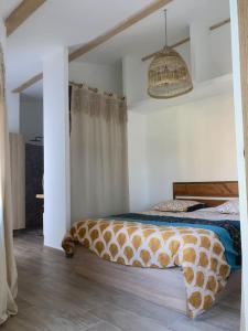 a bedroom with a bed and a pendant light at Maison Piscine Sauna 5min Centre Aix - Casa G. in Aix-en-Provence