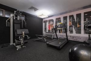 a gym with exercise equipment in a room at Ores Boutique Hotel in Bansko